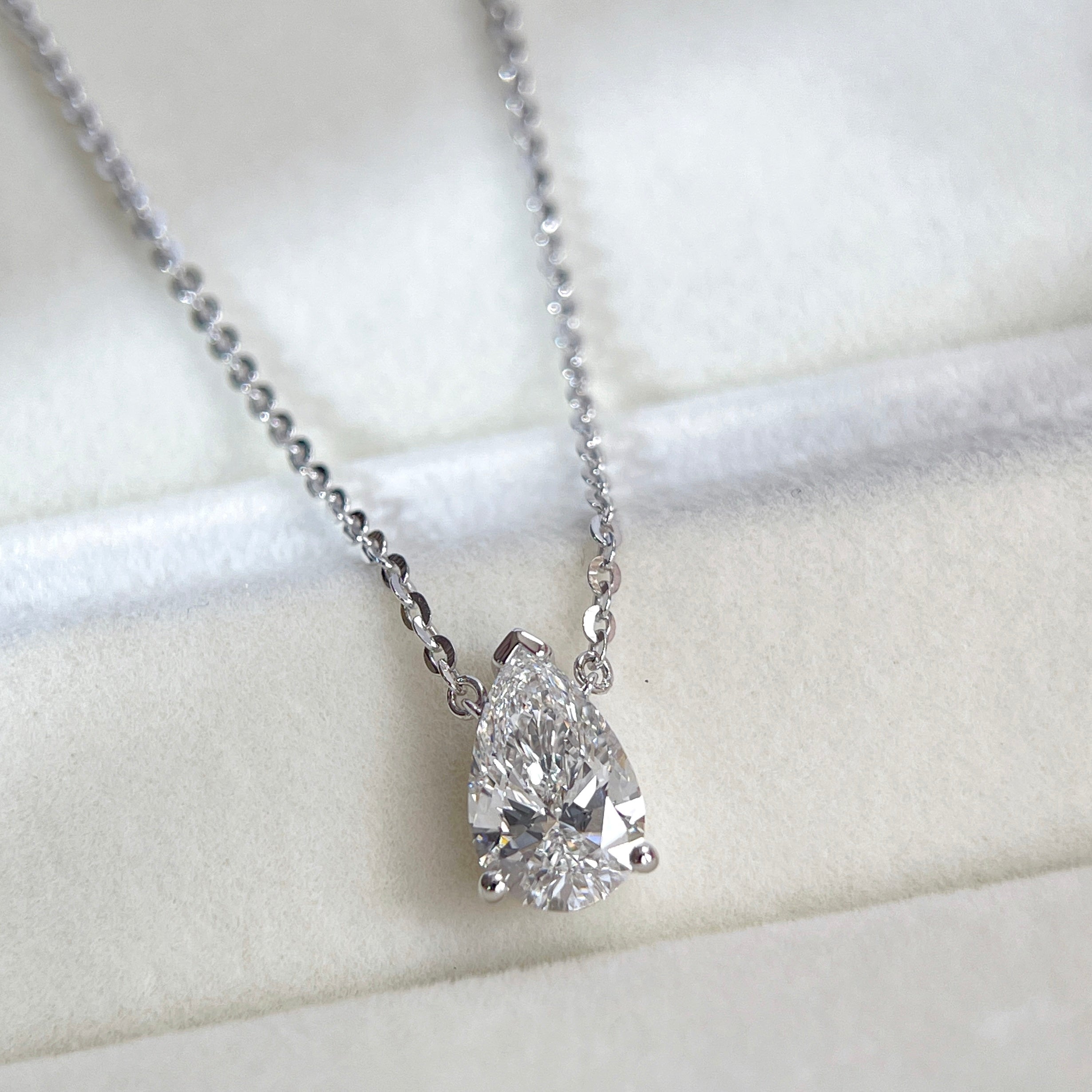 Close-up of a 1.5 carat pear lab grown diamond necklace in S925 sterling silver.