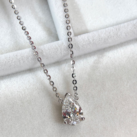 Angled jewelry display of a 1.5 carat pear lab grown diamond necklace in S925 sterling silver.
