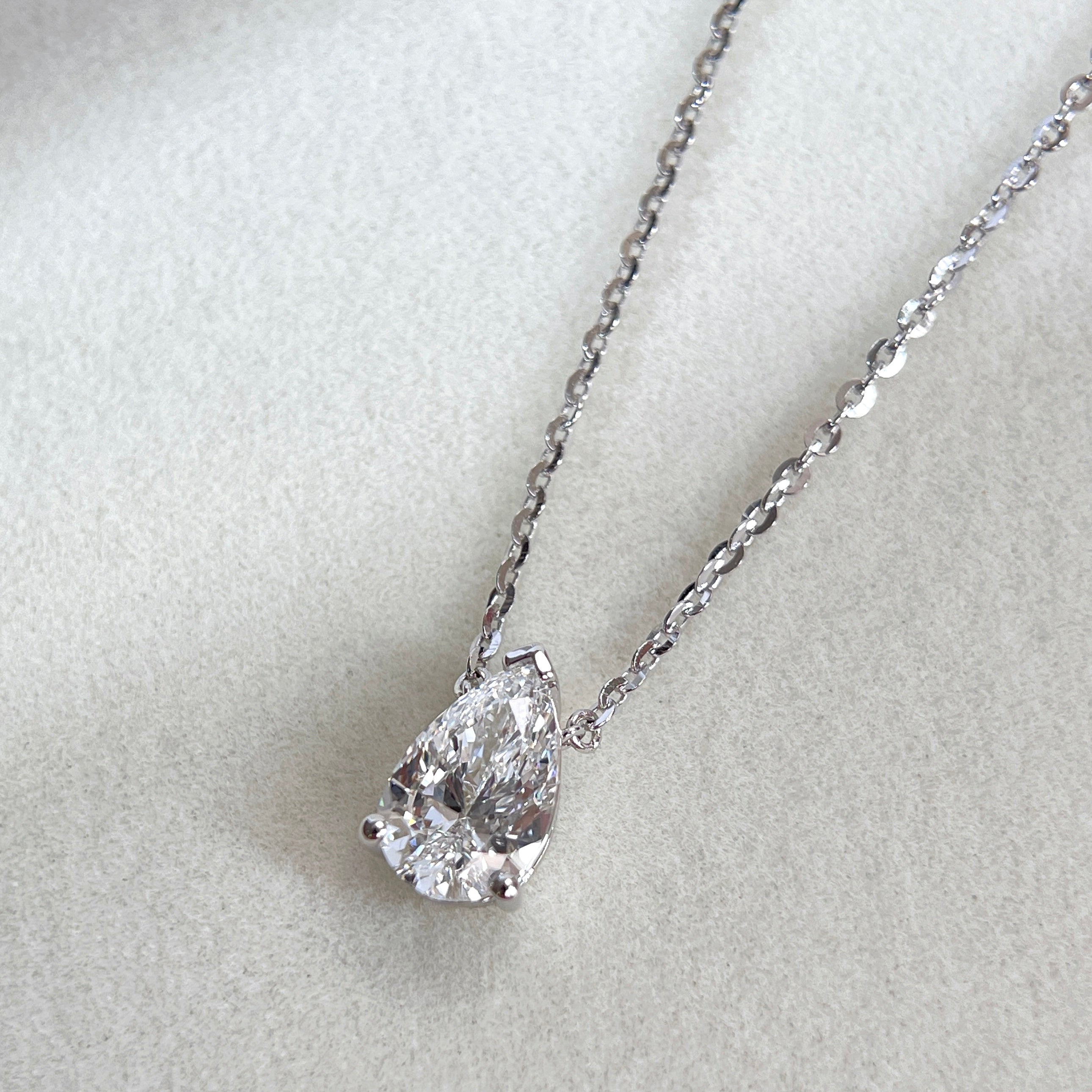 Angled front view of a 1.5 carat pear lab grown diamond necklace in S925 sterling silver.