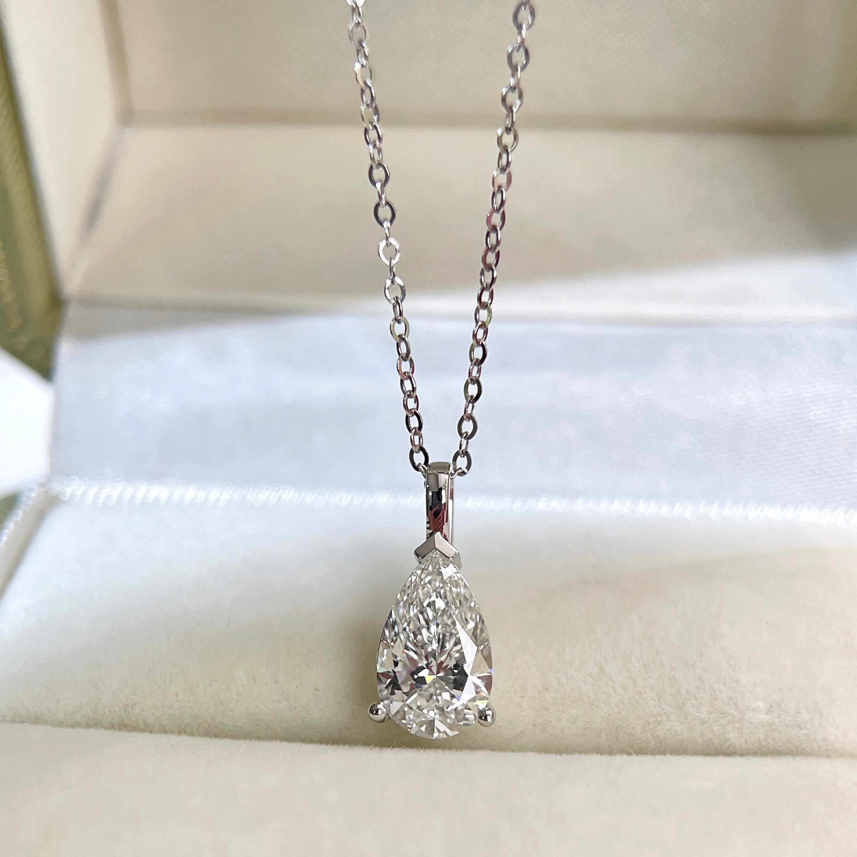 Front presentation of a 1.5 carat pear lab grown diamond pendant in 14K white gold styled on a chain; chain not included.