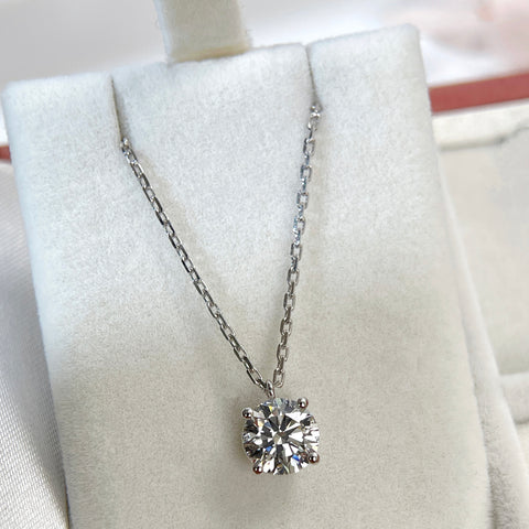 Jewelry display of a 1.5 carat round lab grown diamond fixed pendant necklace in 18K white gold.