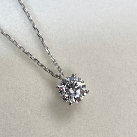 Close-up of a 1.5 carat round lab grown diamond fixed pendant necklace in 18K white gold.