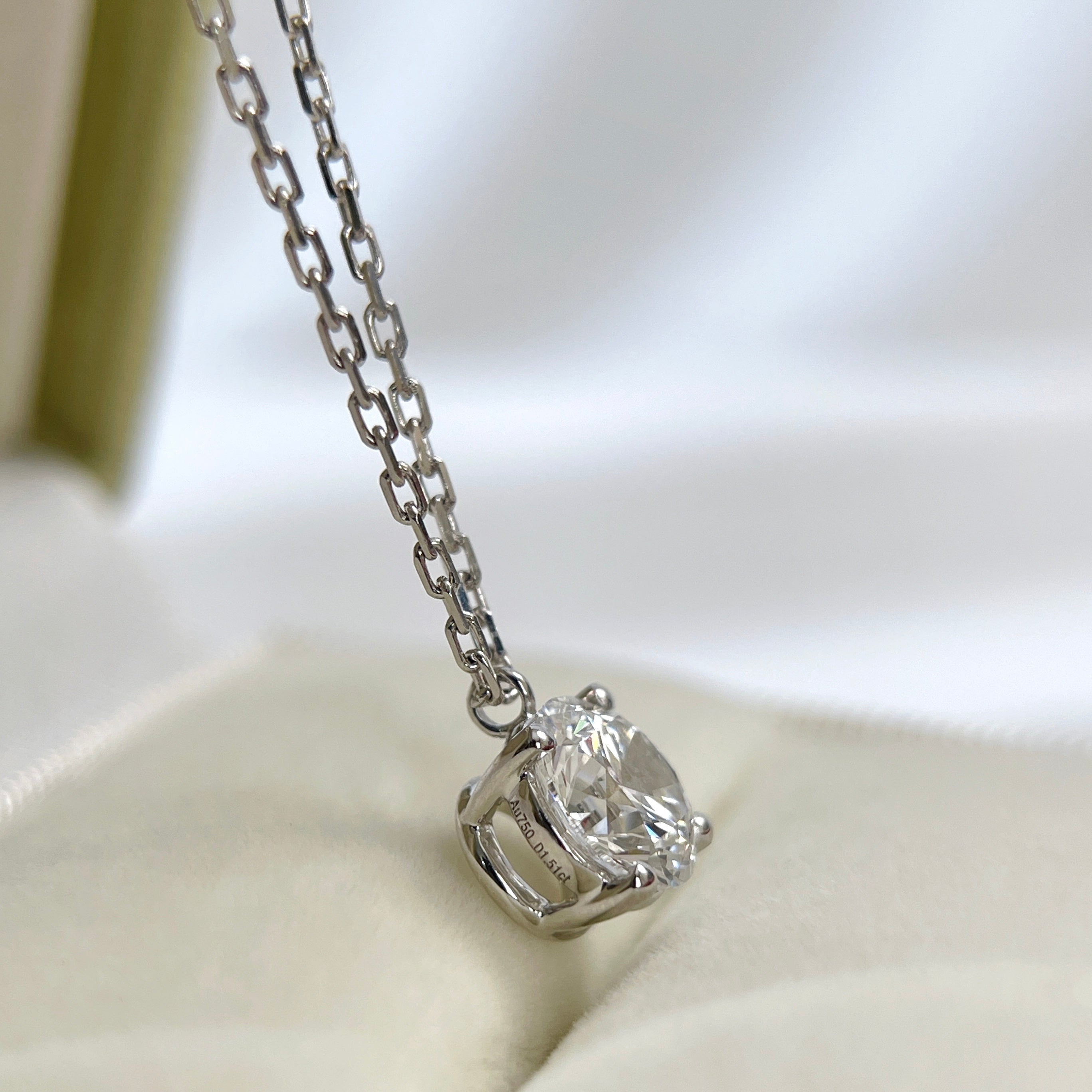 Side view showing the four-prong fixed pendant of a 1.5 carat round lab grown diamond necklace in 18K white gold.