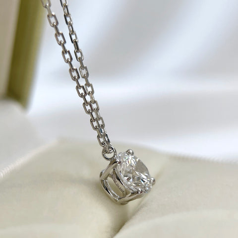 Side view showing the four-prong fixed pendant of a 1.5 carat round lab grown diamond necklace in 18K white gold.