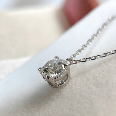 Close-up of the four-prong fixed pendant setting on a 1.5 carat round lab grown diamond necklace.