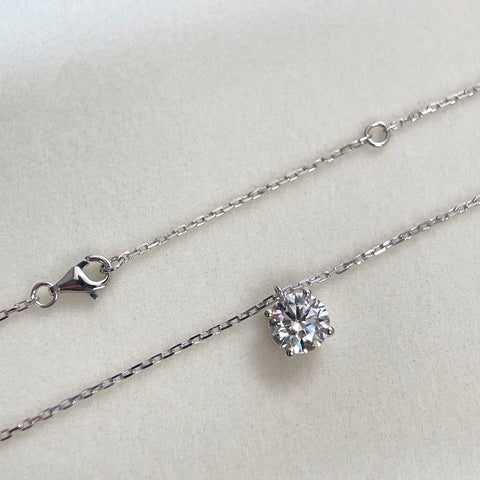 Full view of the substantial square-link chain and lobster clasp on an 18K white gold diamond necklace.