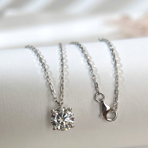 Substantial square-link chain and lobster clasp detail on an 18K white gold diamond necklace.