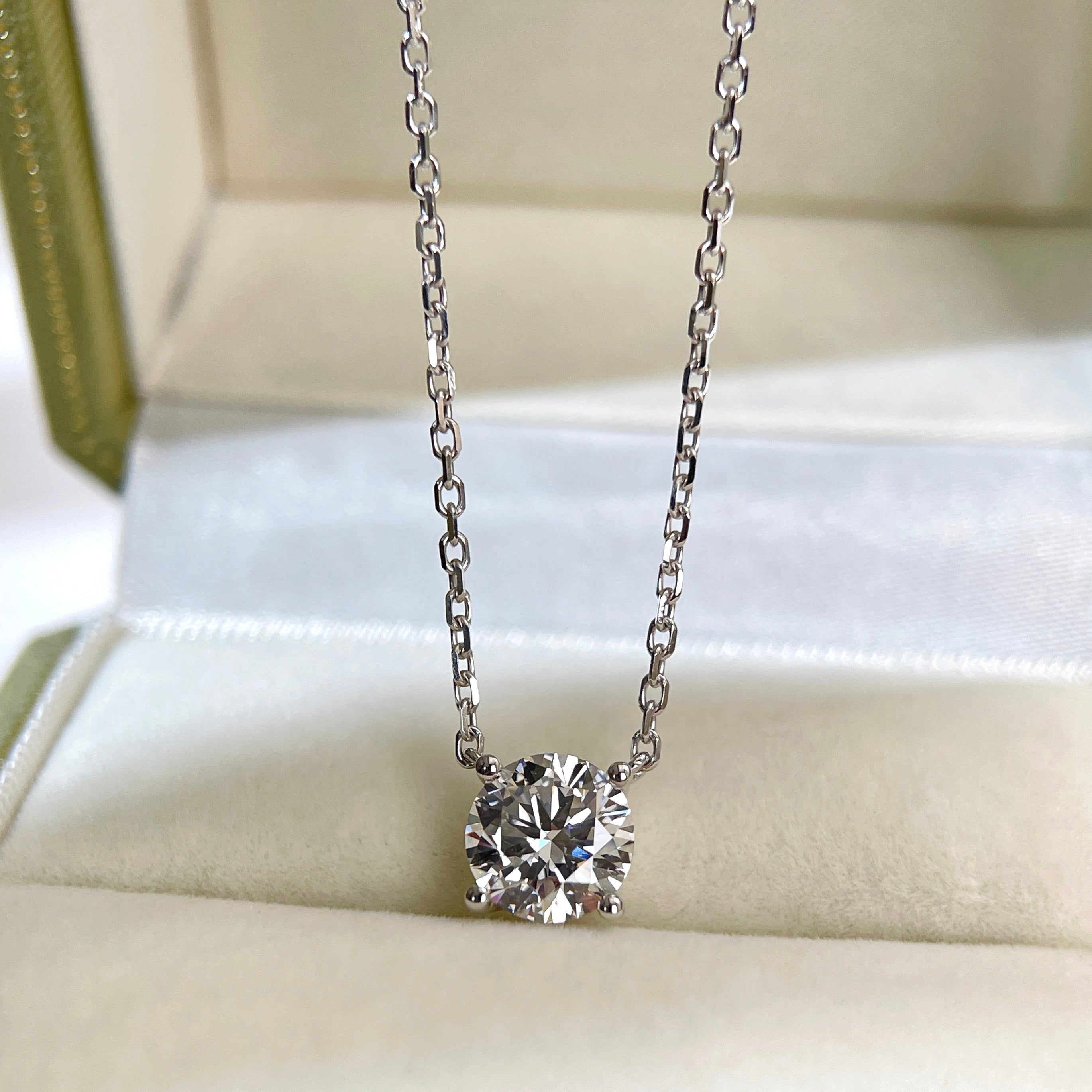 Front presentation of a 1.5 carat round lab grown diamond necklace in 18K white gold.