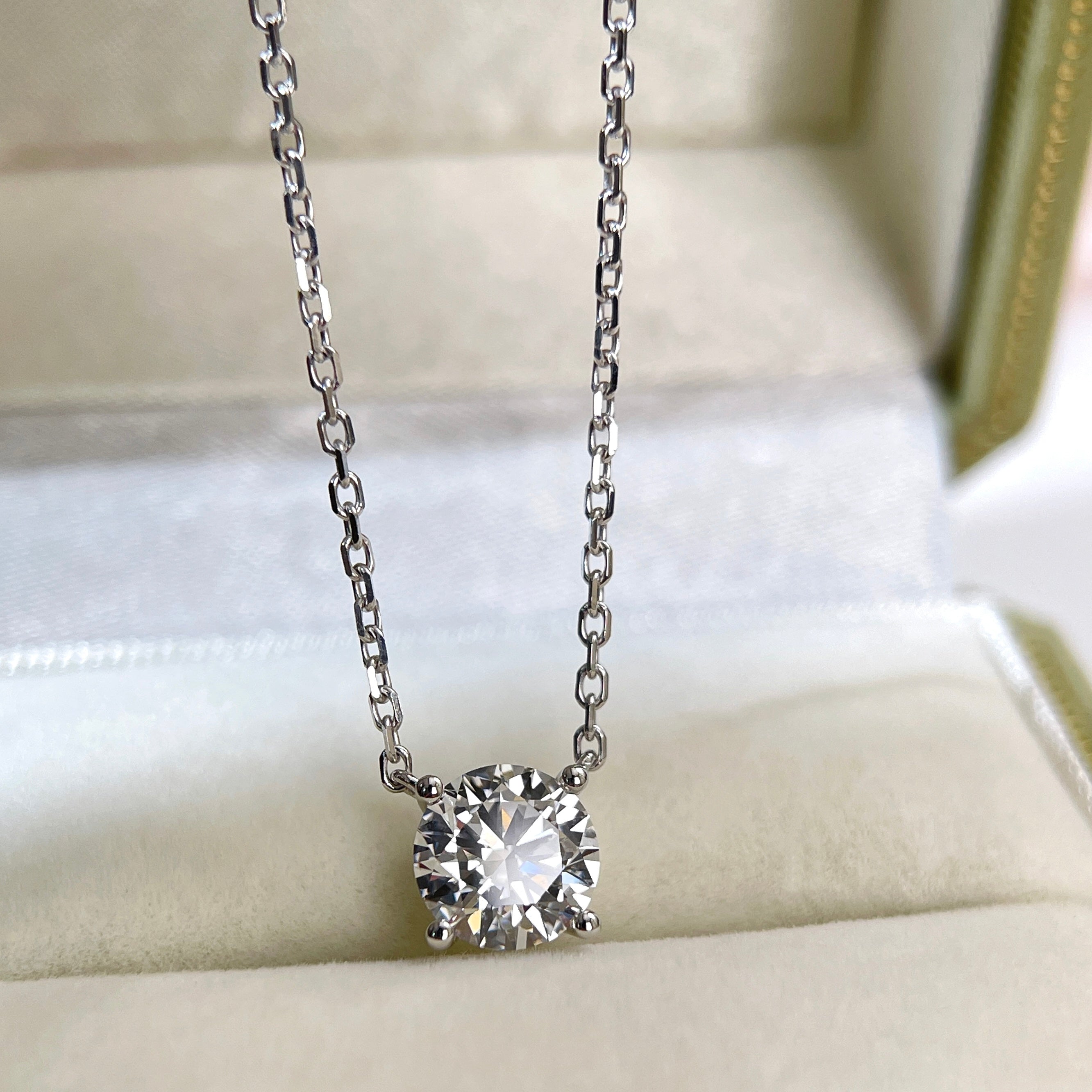 Front view of a 1.5 carat round lab grown diamond necklace in 18K white gold.