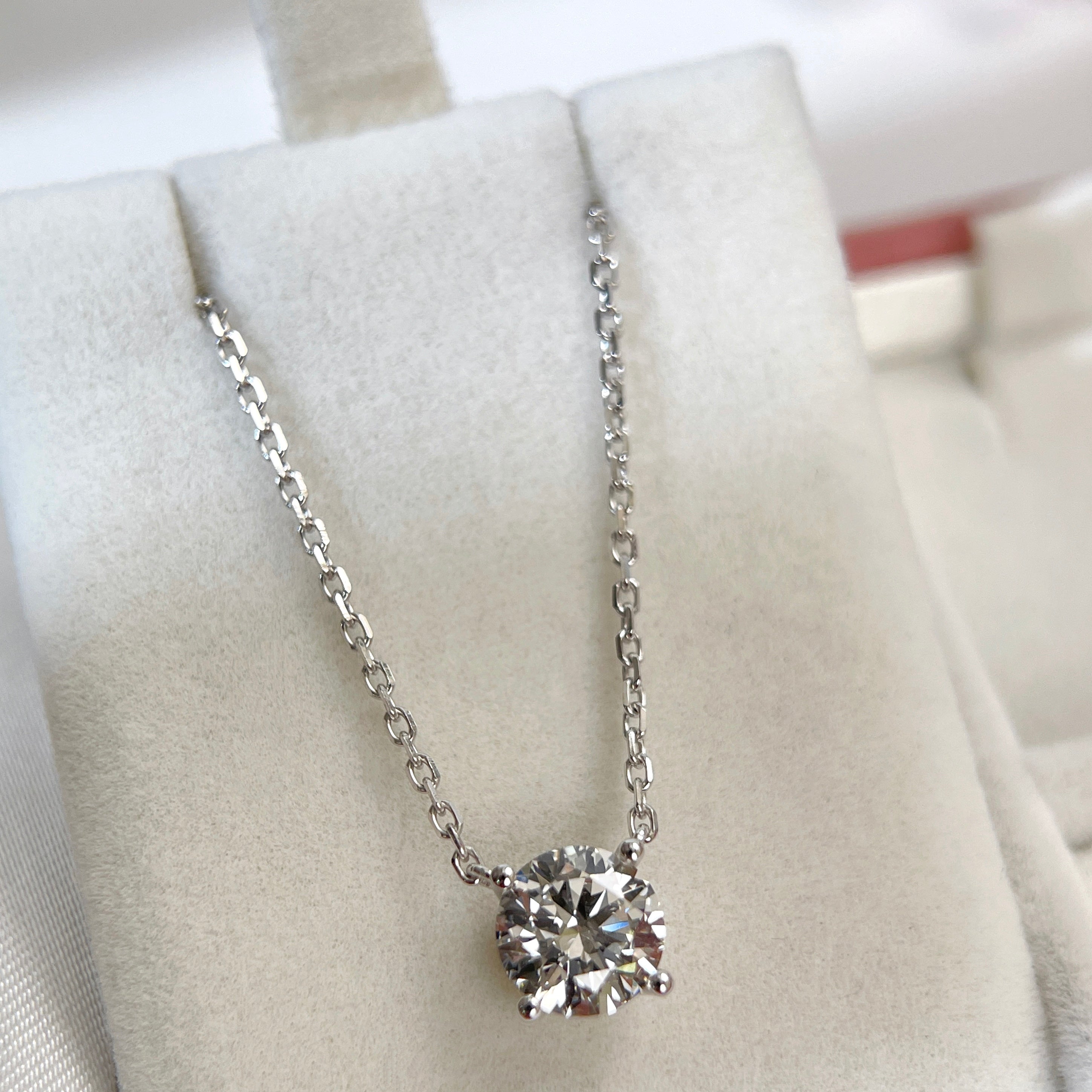 Full display of a 1.5 carat round lab grown diamond necklace in 18K white gold.