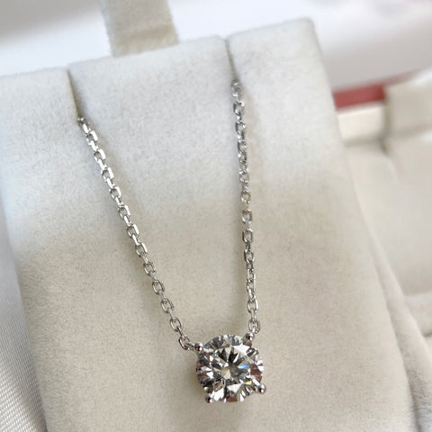 Full display of a 1.5 carat round lab grown diamond necklace in 18K white gold.