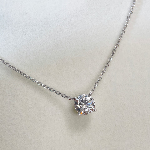 Diamond detail of a 1.5 carat D/VVS2 round lab grown diamond necklace in 18K white gold.