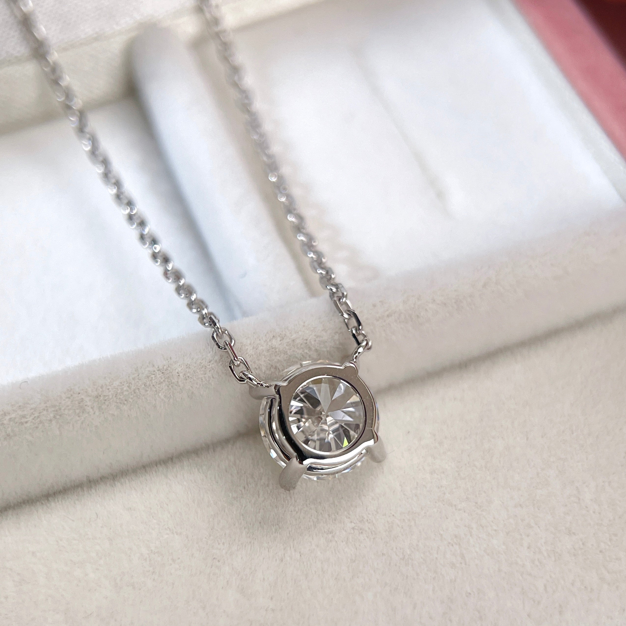 Back view showing the four-prong fixed pendant of a 1.5 carat round lab grown diamond necklace in 18K white gold.