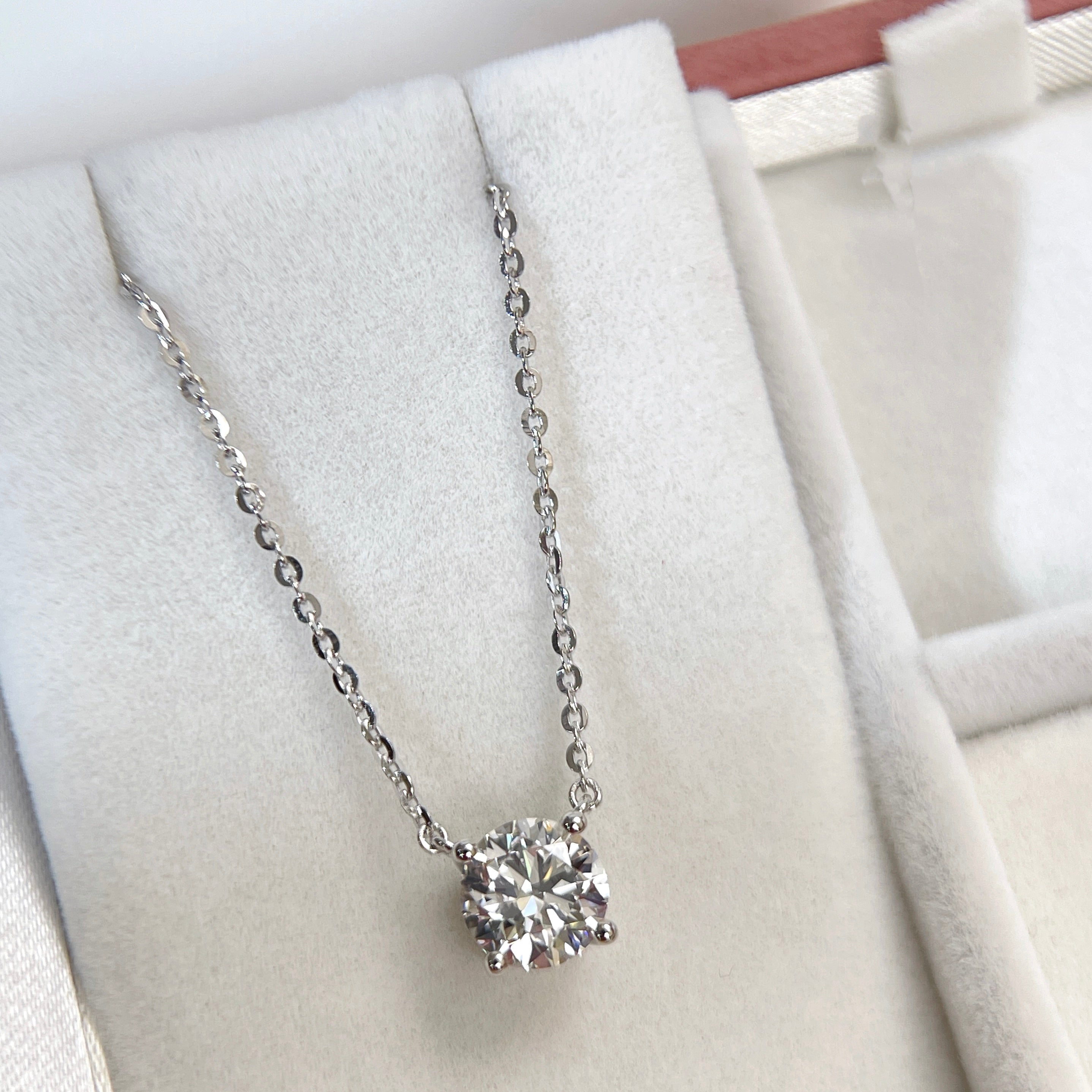 Jewelry display of a 1.5 carat round lab grown diamond necklace in S925 sterling silver.