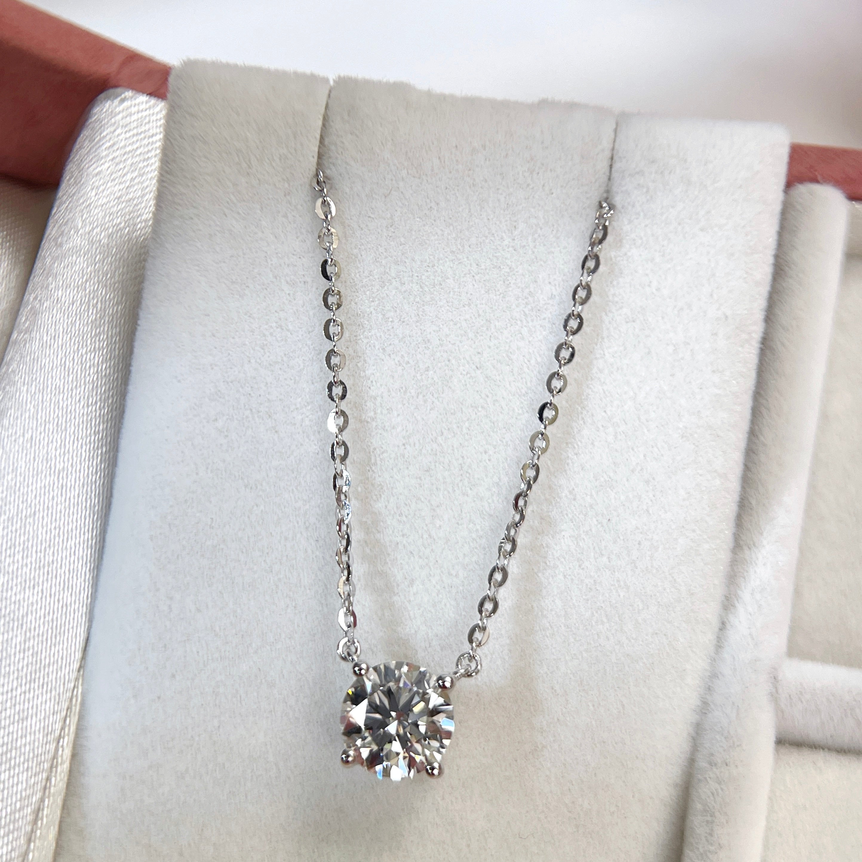 Jewelry display of a 1.5 carat round lab grown diamond necklace in S925 sterling silver.