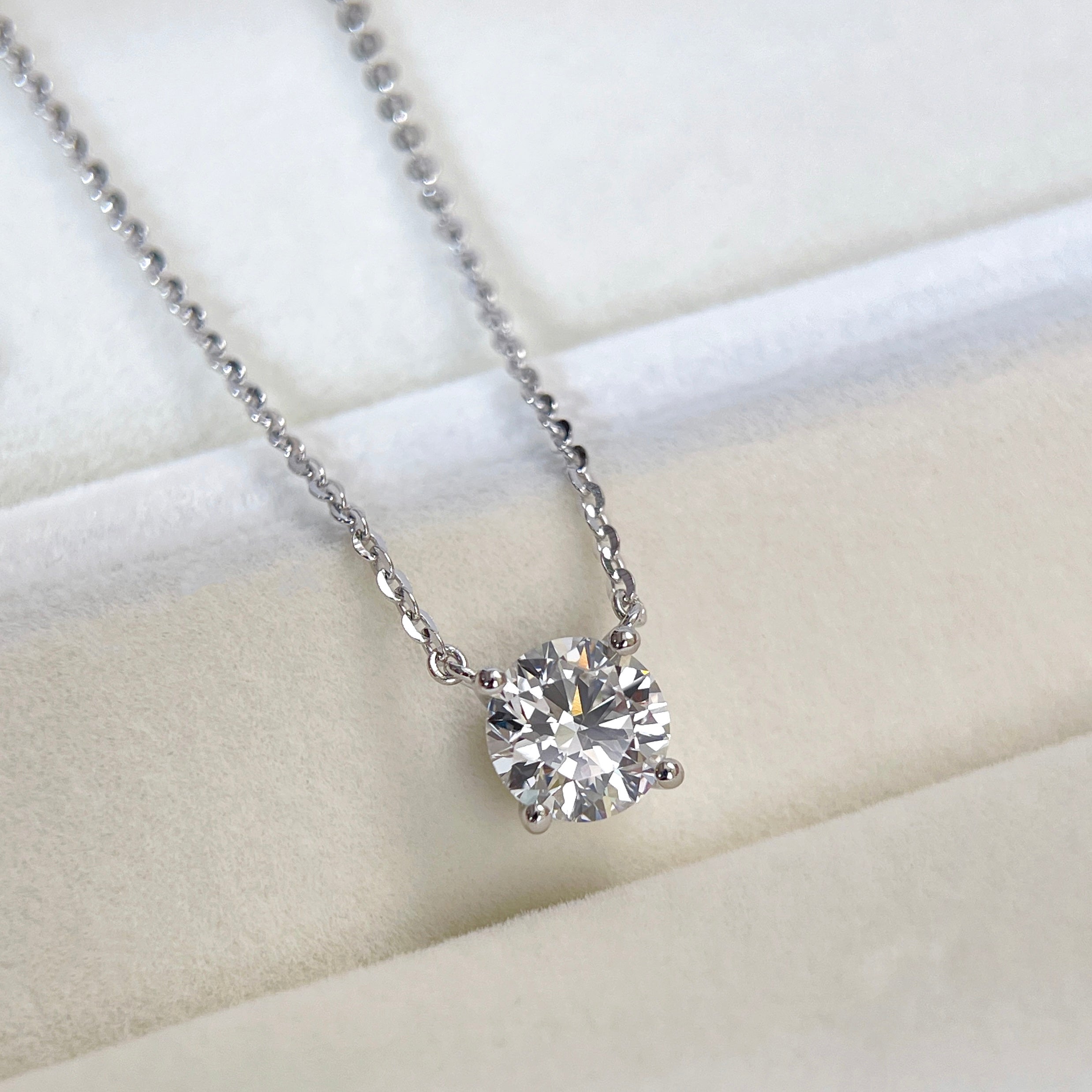 Angled view of a 1.5 carat round lab grown diamond necklace in S925 sterling silver.
