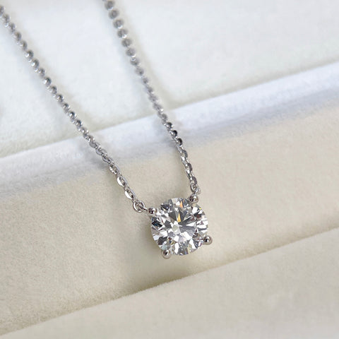 Angled view of a 1.5 carat round lab grown diamond necklace in S925 sterling silver.