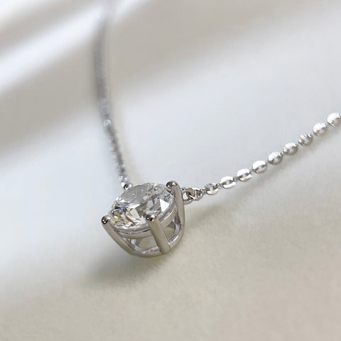 Side view showing the four-prong setting of a 1.5 carat round lab grown diamond necklace in S925 sterling silver.