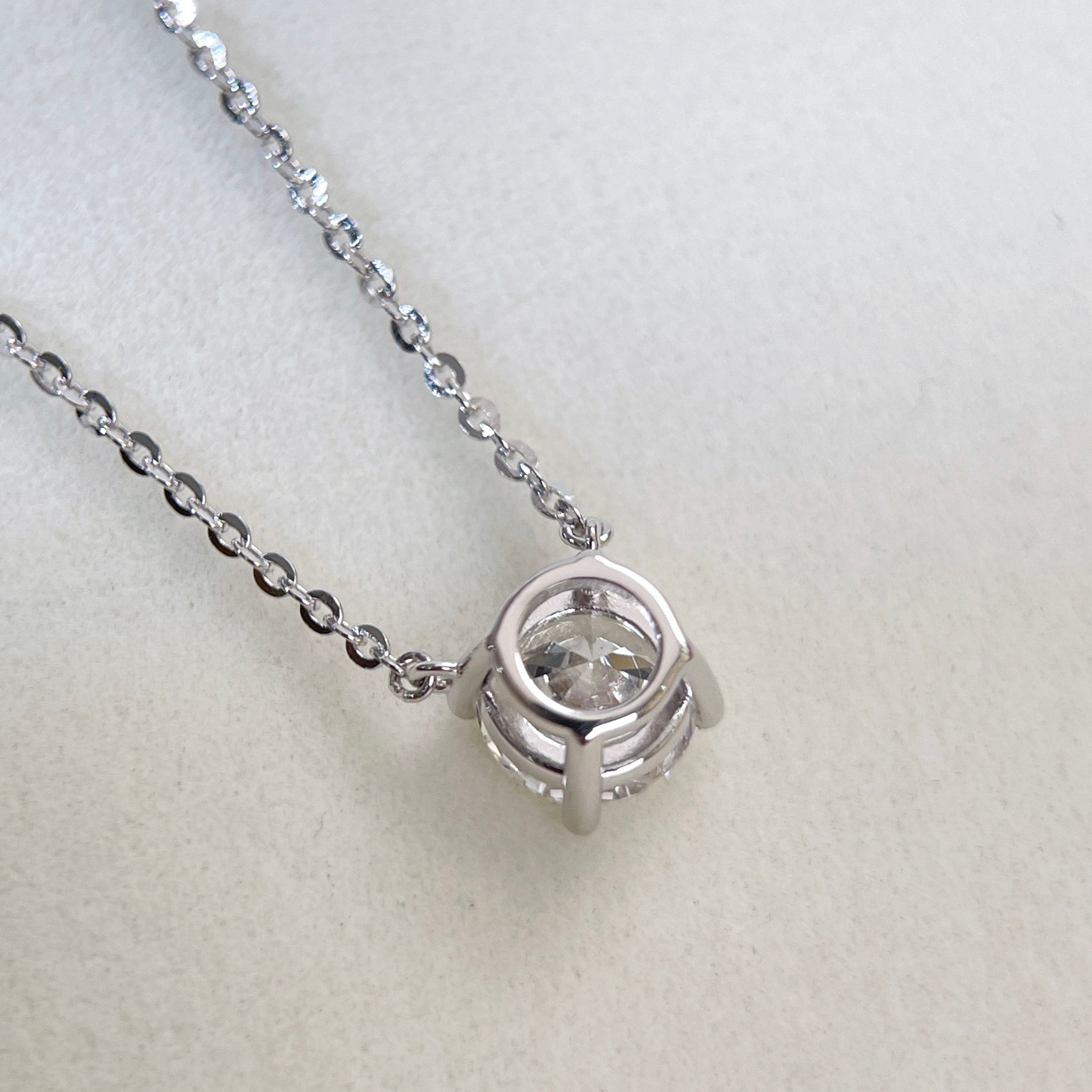 Back view showing the four-prong setting of a 1.5 carat round lab grown diamond necklace in S925 sterling silver.
