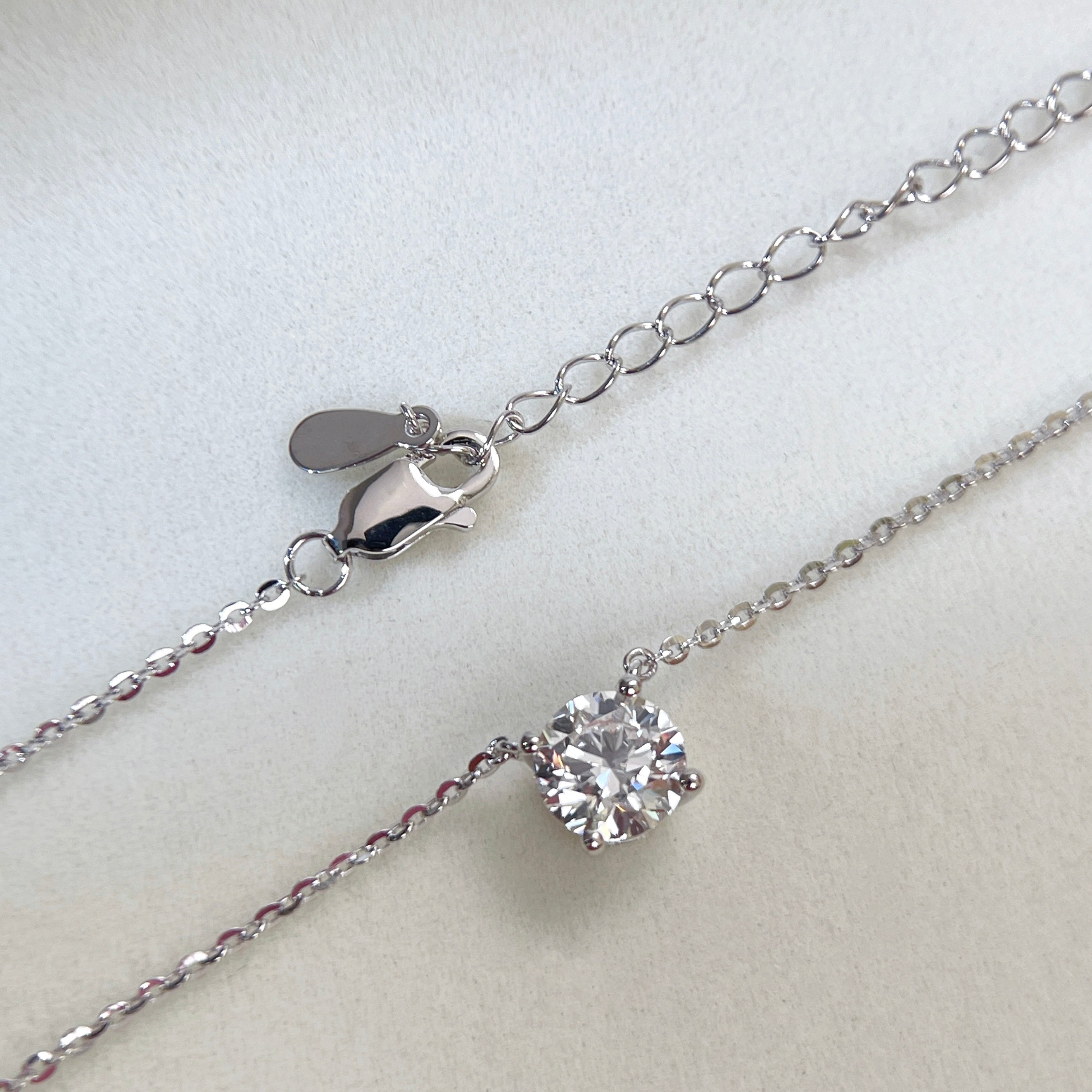 Adjustable extender and lobster clasp detail of a 1.5 carat round lab grown diamond necklace in S925 sterling silver.