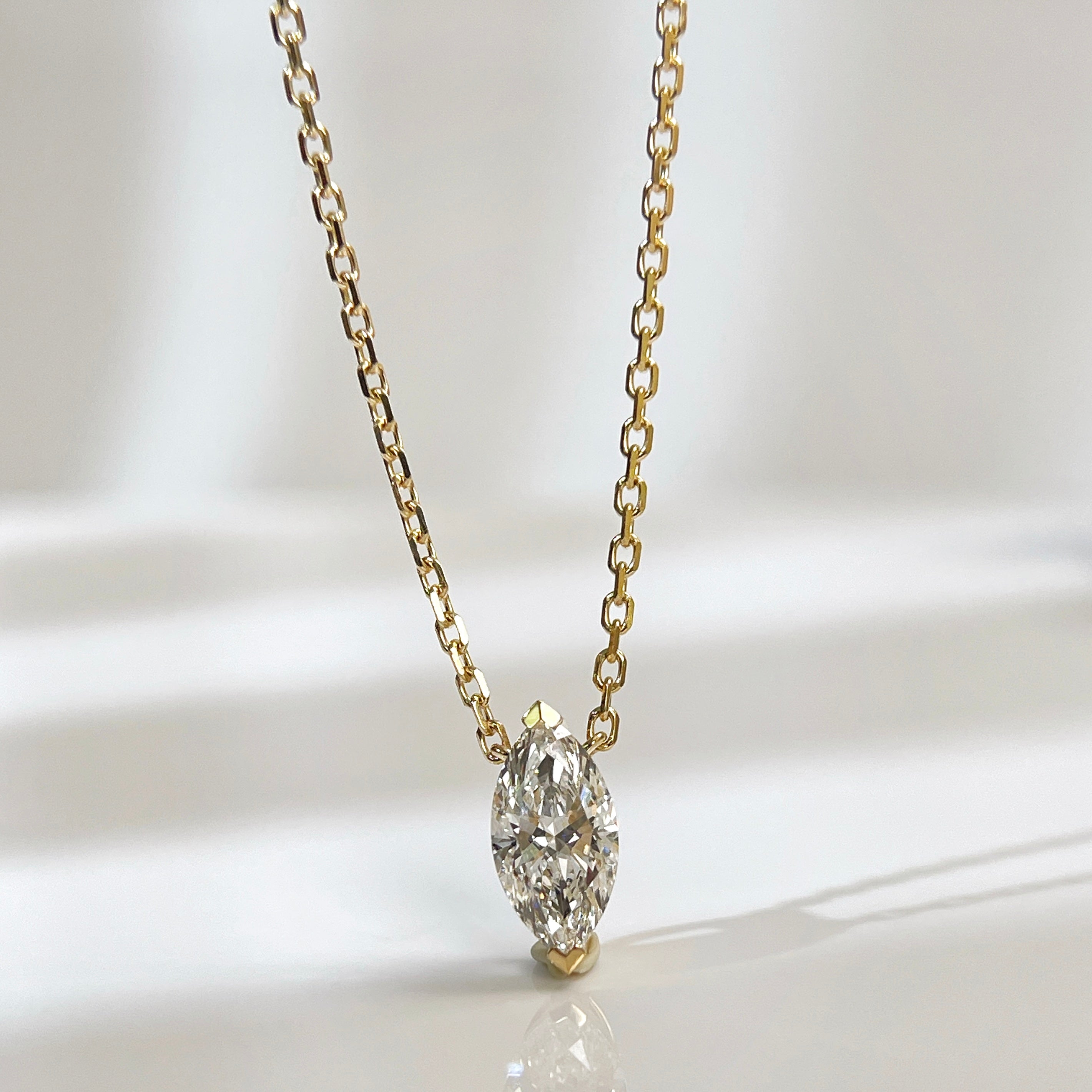 Front presentation of a 1 carat D/VVS2 marquise lab grown diamond necklace in 18K yellow gold.