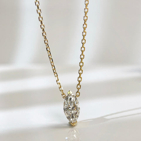 Front presentation of a 1 carat D/VVS2 marquise lab grown diamond necklace in 18K yellow gold.
