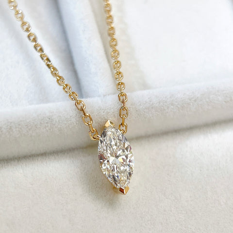 Diamond detail of a 1 carat D/VVS2 marquise lab grown diamond necklace in 18K yellow gold.