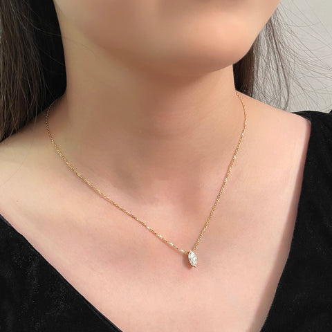 Model wearing a 1 carat marquise lab grown diamond necklace in 18K yellow gold.