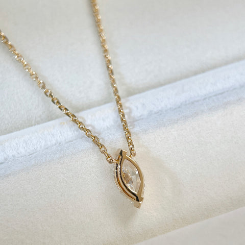 Back view showing the two-prong setting of a 1 carat marquise lab grown diamond necklace in 18K yellow gold.