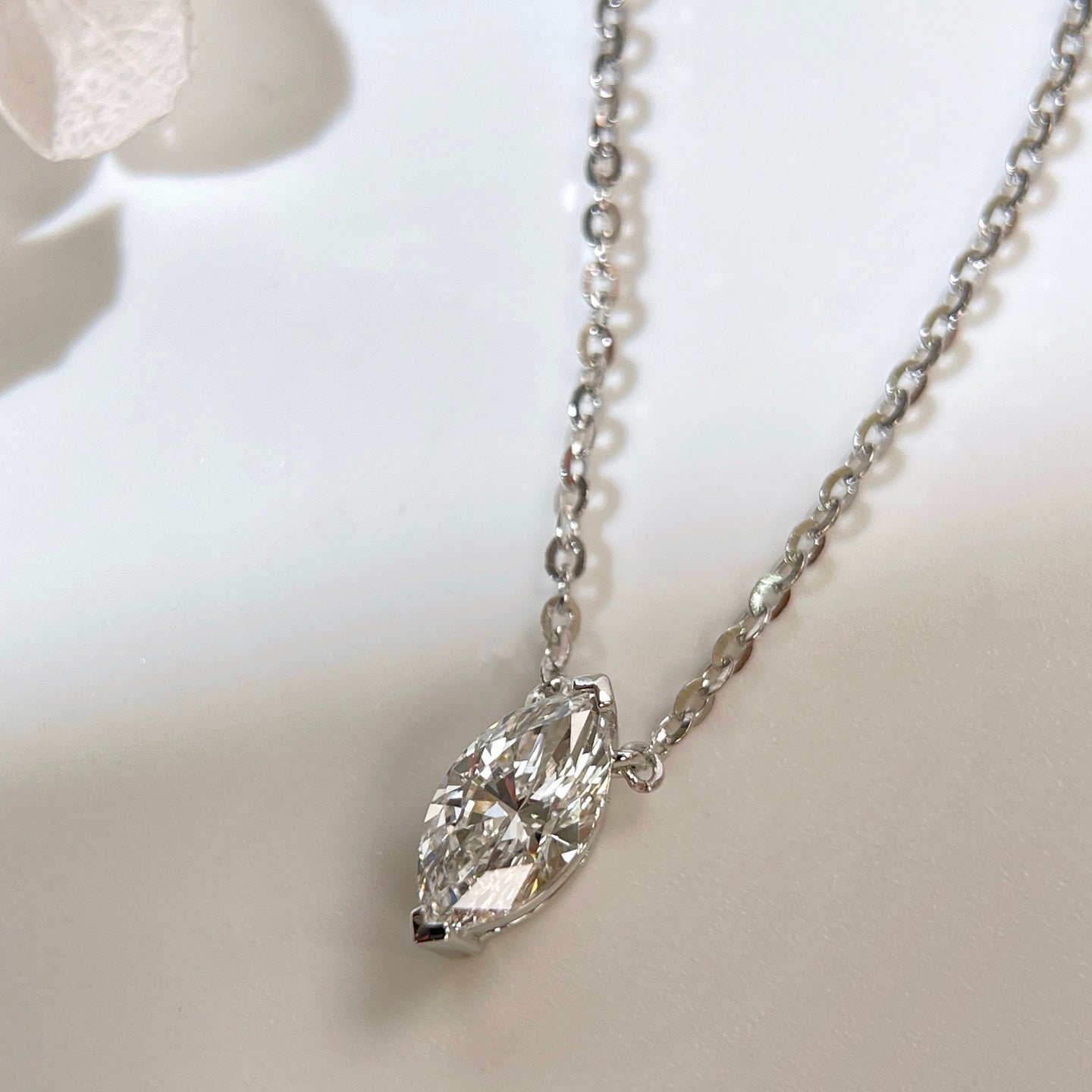 Diamond detail of a 1 carat D/VVS2 marquise lab grown diamond necklace in S925 sterling silver.