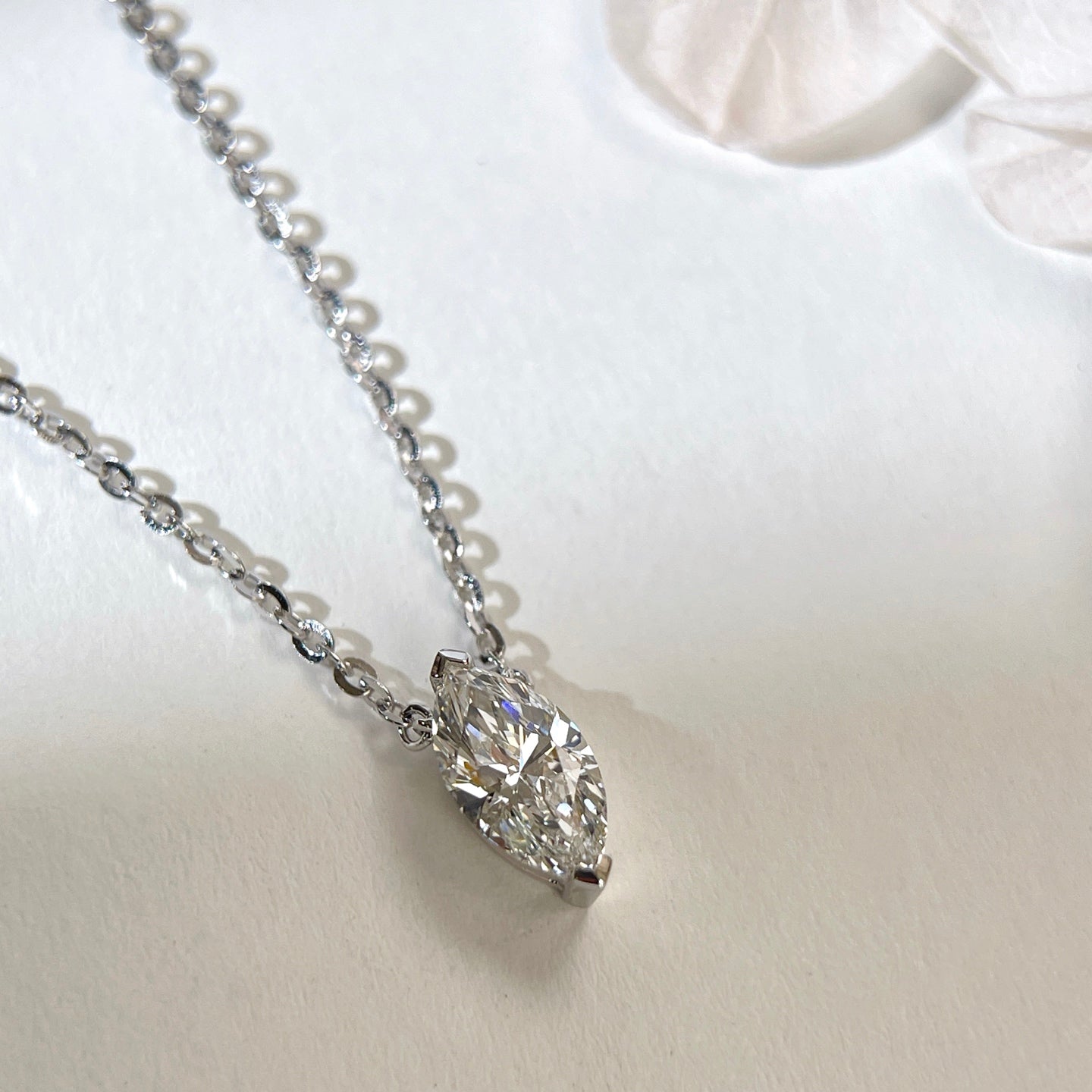 Angled view of a 1 carat marquise lab grown diamond necklace in S925 sterling silver.