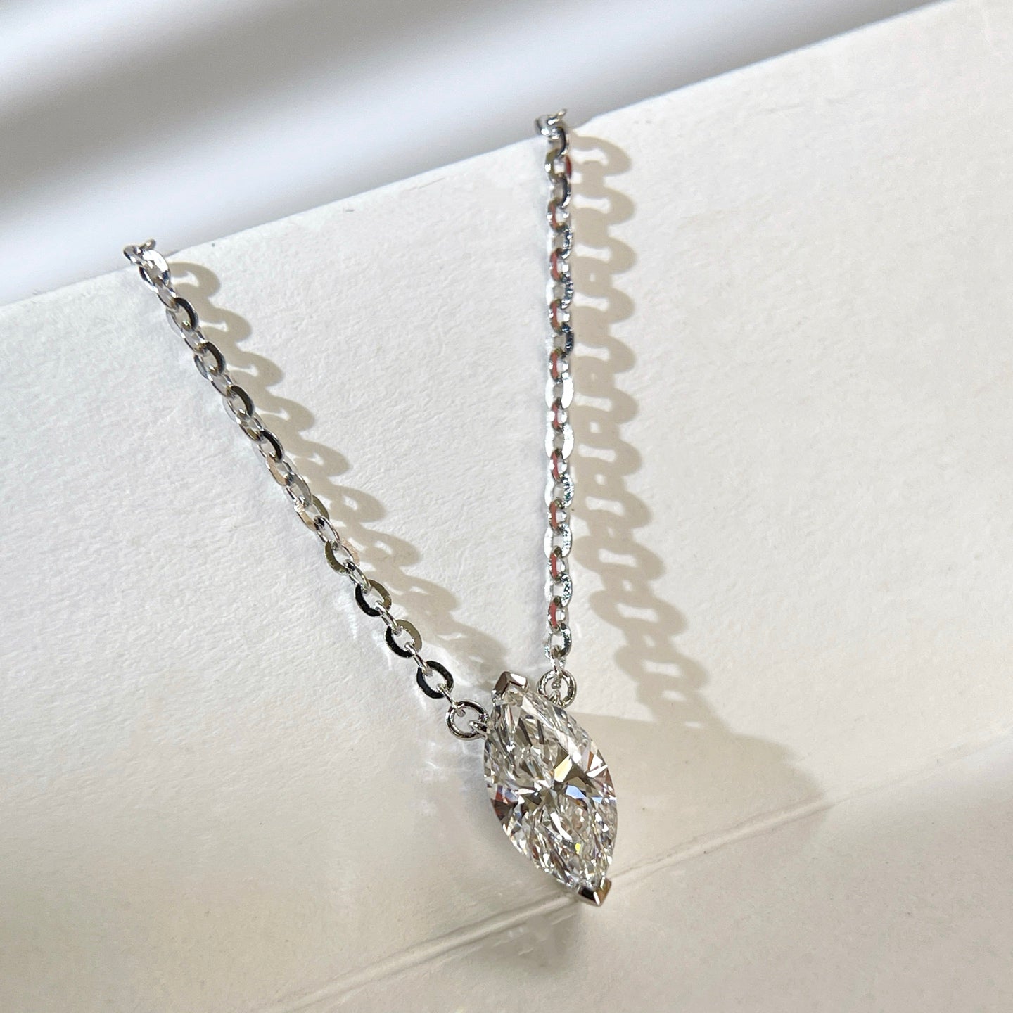Close-up of a 1 carat marquise lab grown diamond necklace in S925 sterling silver.