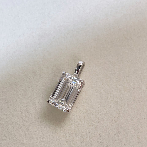 Front view of a detachable 2 ct emerald-cut lab grown diamond pendant in 18K white gold