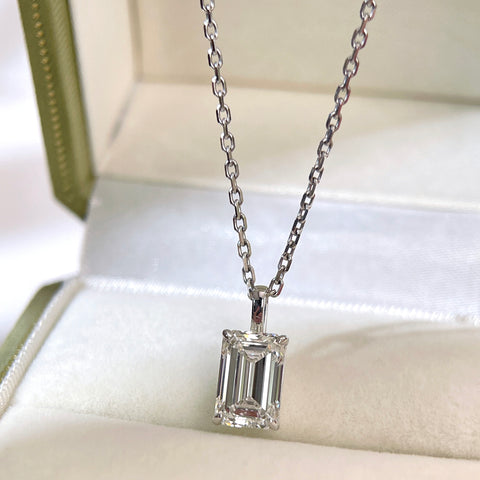 Emerald-cut lab grown diamond pendant and separate chain displayed in a jewelry box