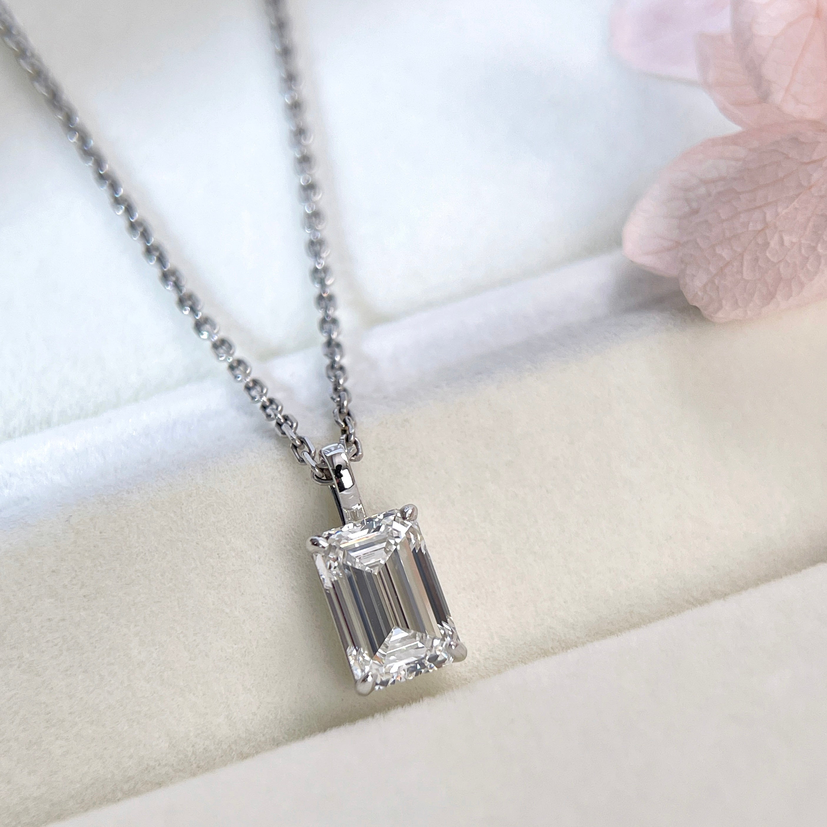 Lifestyle display of a 2 ct emerald-cut lab grown diamond pendant with a separate chain
