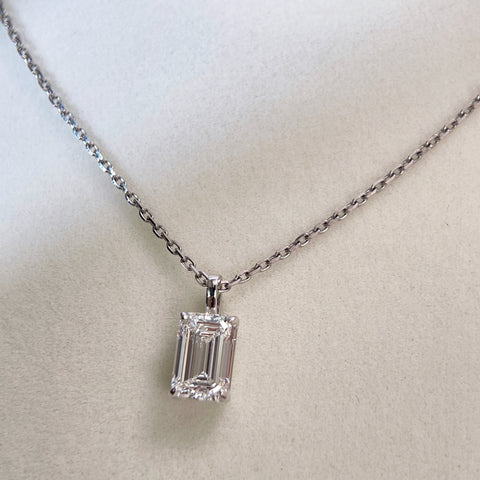 Centered display of a 2 ct emerald-cut lab grown diamond pendant on its separate chain