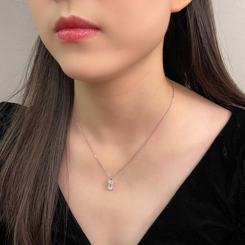 Model wearing an emerald-cut lab grown diamond 18K white gold pendant and chain