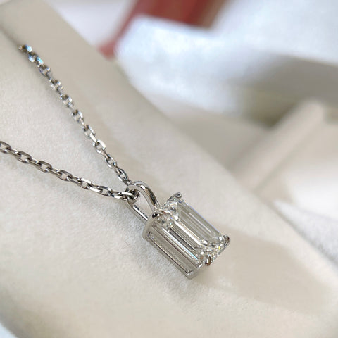 Angled detail of the four-prong basket and bail on a 2 ct emerald-cut lab grown diamond pendant