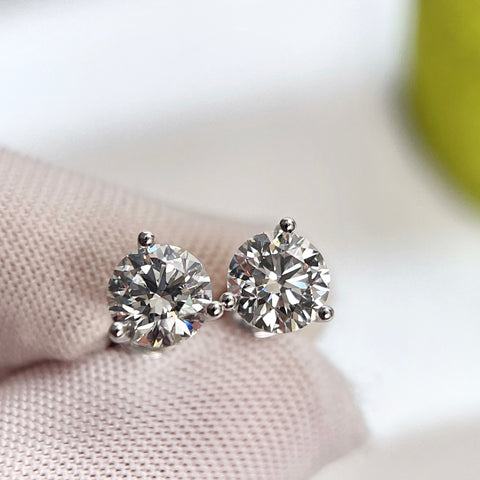 Front close-up of 2 CTW round lab grown diamond three-prong Martini stud earrings