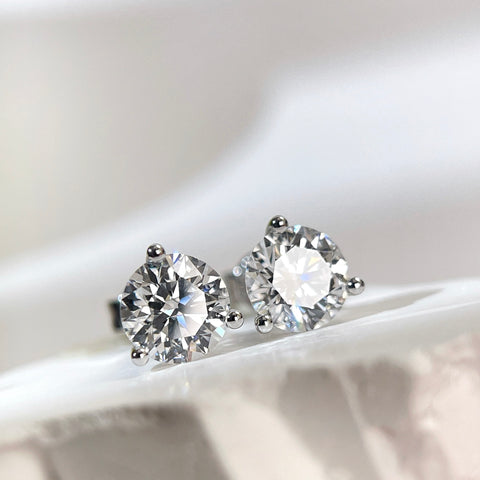Angled front view of D VVS2 round lab grown diamond Martini stud earrings