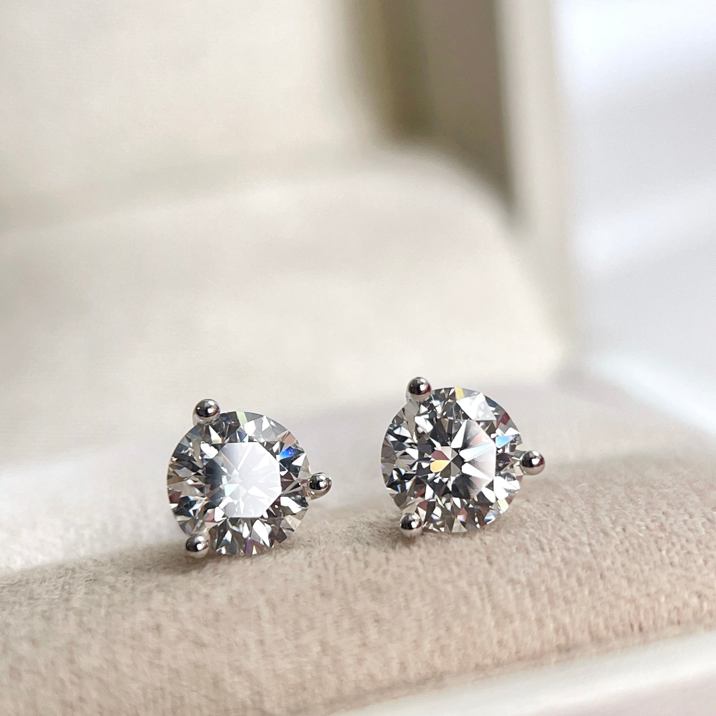 2 CTW lab grown diamond three-prong Martini stud earrings displayed in a jewelry box