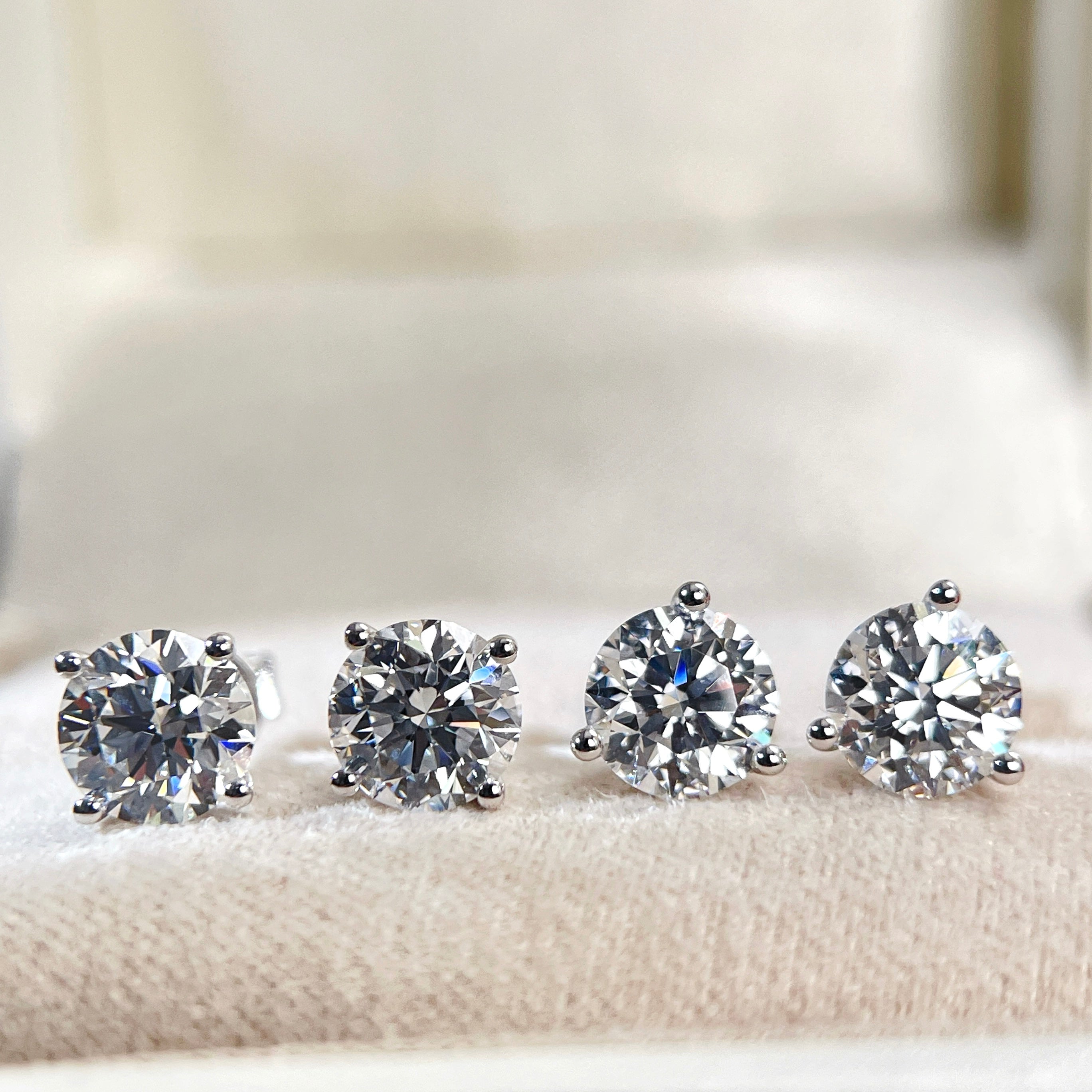 Front comparison of four-prong and three-prong Martini round diamond stud settings
