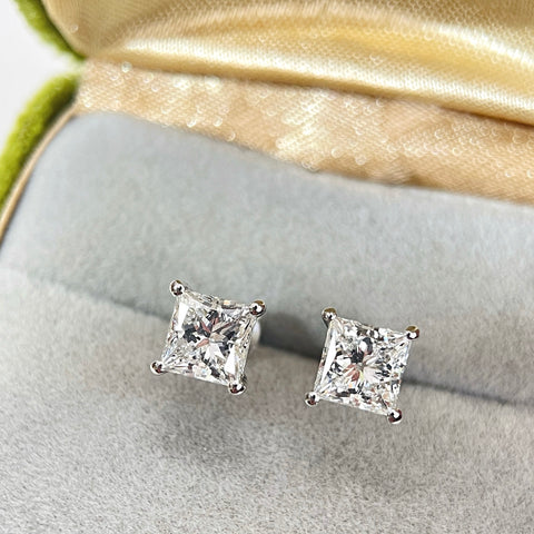 Princess-cut lab-grown diamond stud earrings displayed in a jewelry box