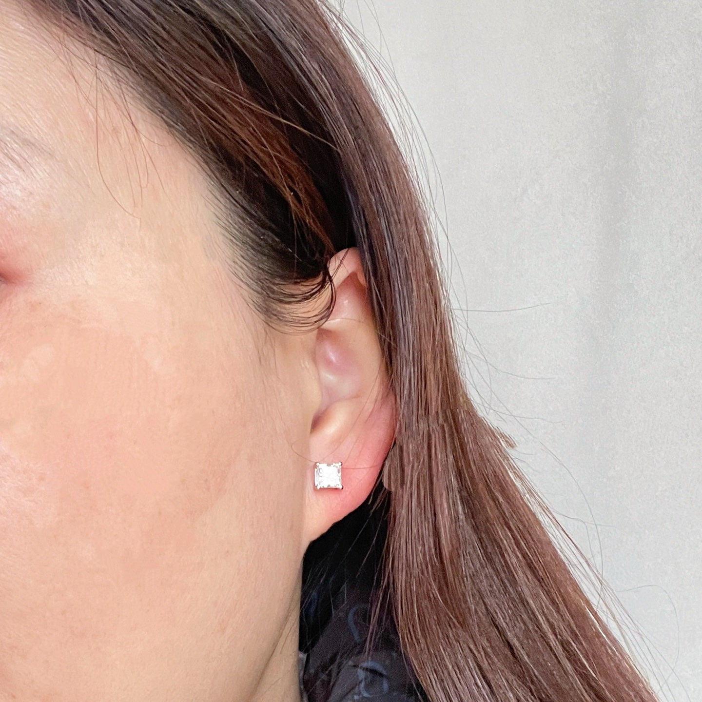 Model wearing 2 CTW princess-cut lab-grown diamond stud earrings
