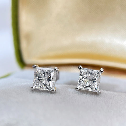 Close-up jewelry box view of princess-cut lab-grown diamond stud earrings