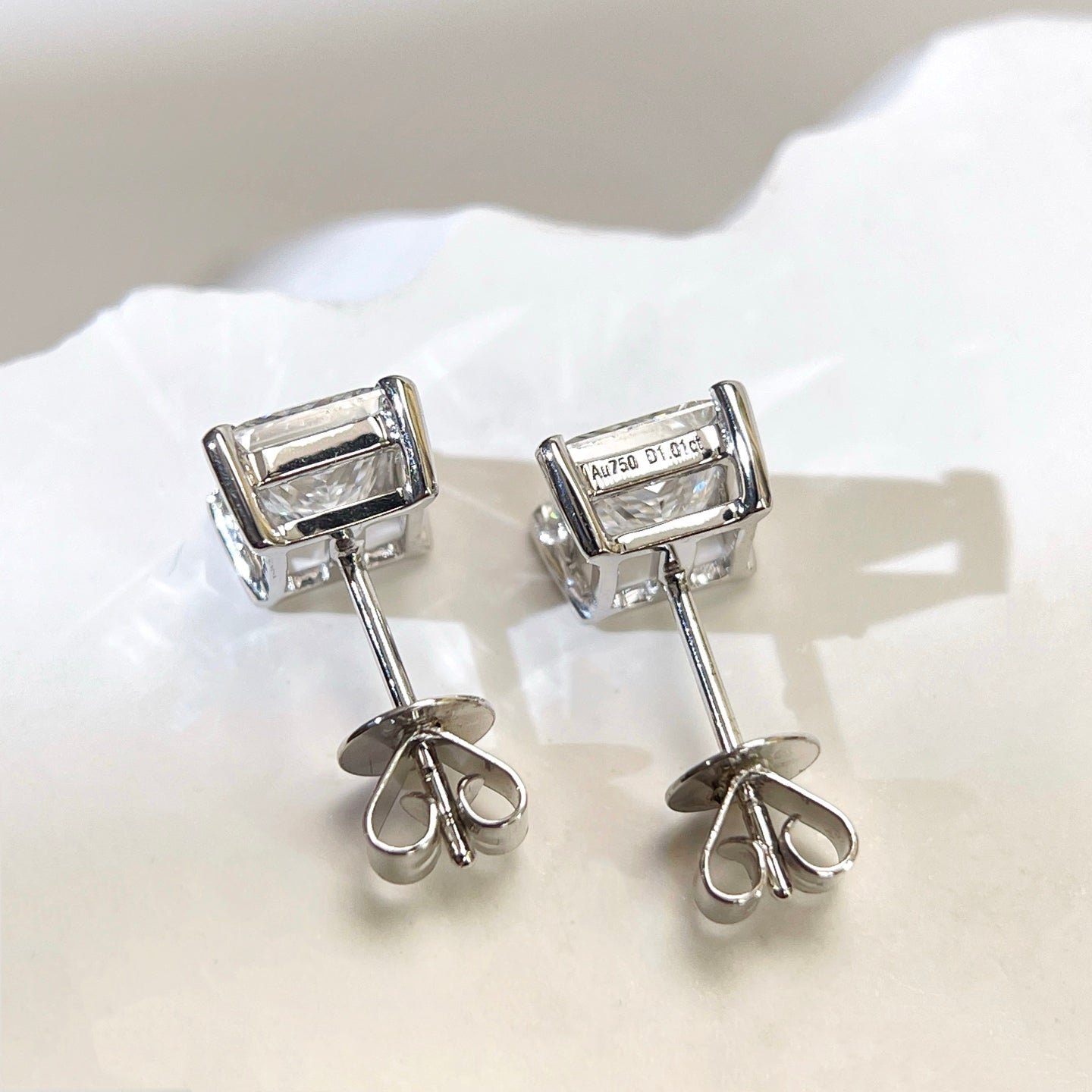 Back view of 18K white gold princess-cut diamond stud earrings with push backs