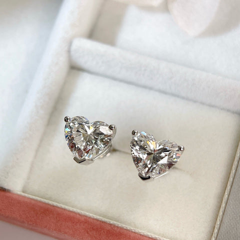 Heart-shaped lab-grown diamond stud earrings displayed in a jewelry box