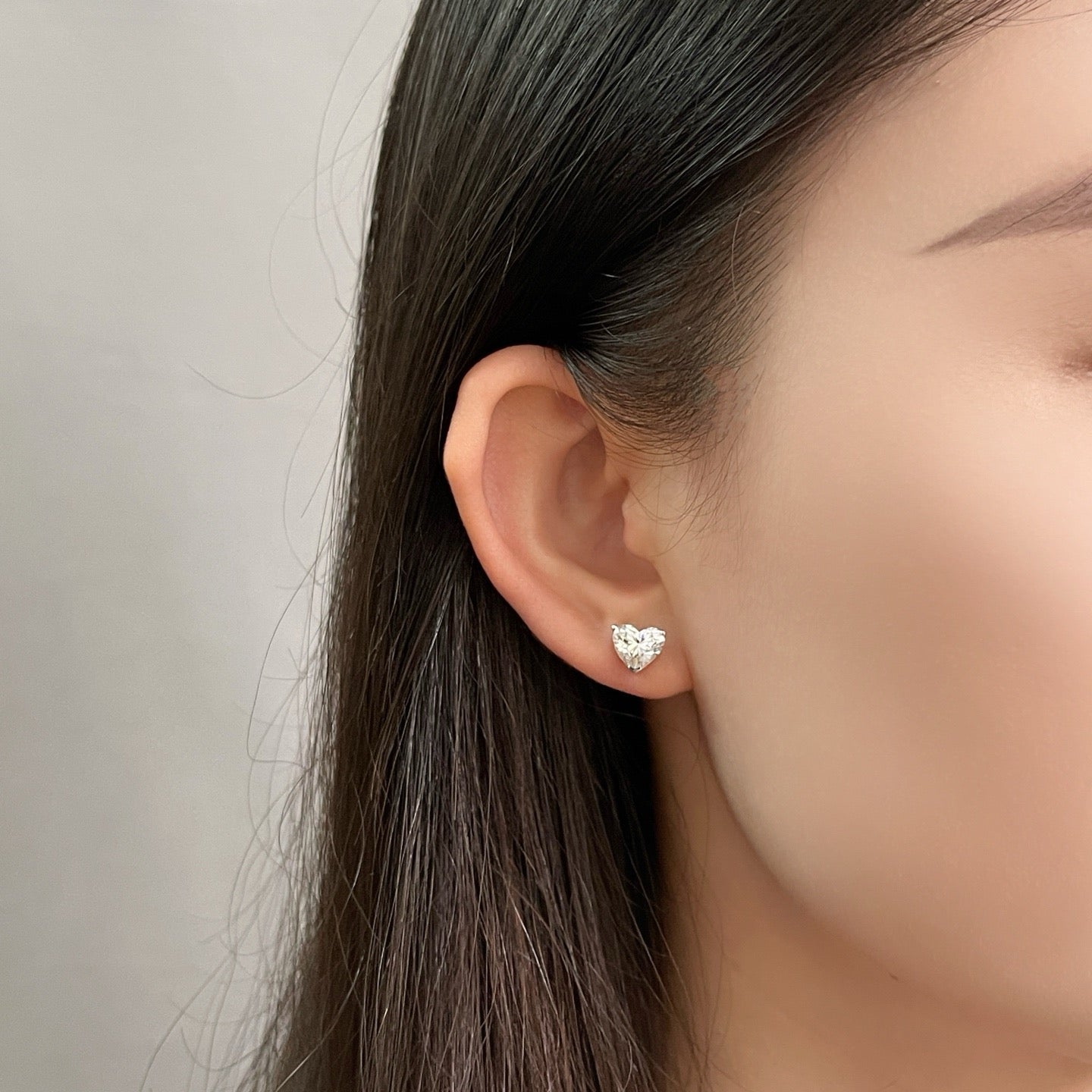 Close-up of a model wearing 3 CTW heart-shaped lab-grown diamond stud earrings