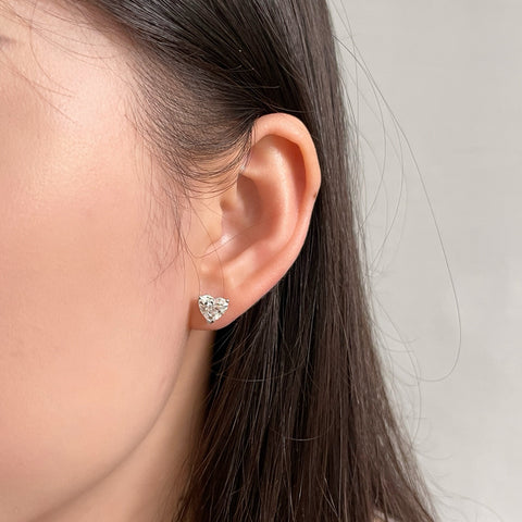 Model wearing 3 CTW heart-shaped lab-grown diamond stud earrings