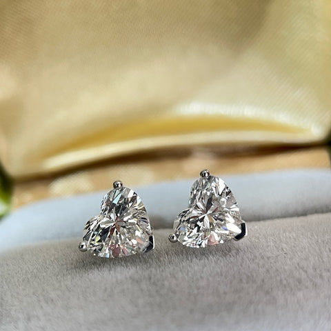 Front display view of heart-shaped lab-grown diamond three-prong stud earrings